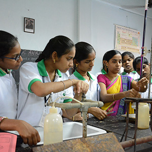 Girls conducting lab experiments under faculty guidance in the KBN College science lab
